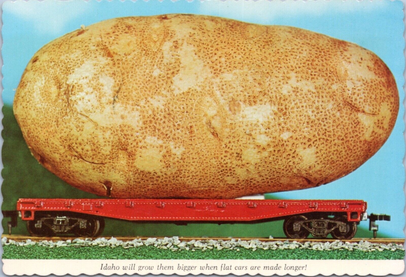 Postcard Exaggeration - Giant Idaho potato on flat train car