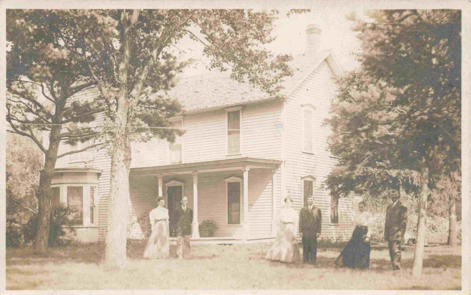 A View Of A Family Posing In Front Of Their Home, Farnhamville, Iowa IA RPPC