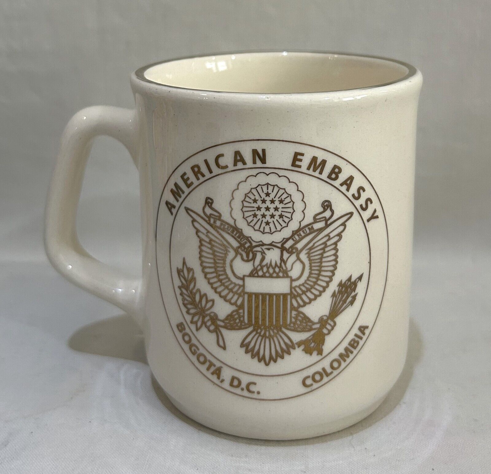 American Embassy to Bogota Colombia VTG Ceramic Mug Ivory Color Gold Crest 8 oz