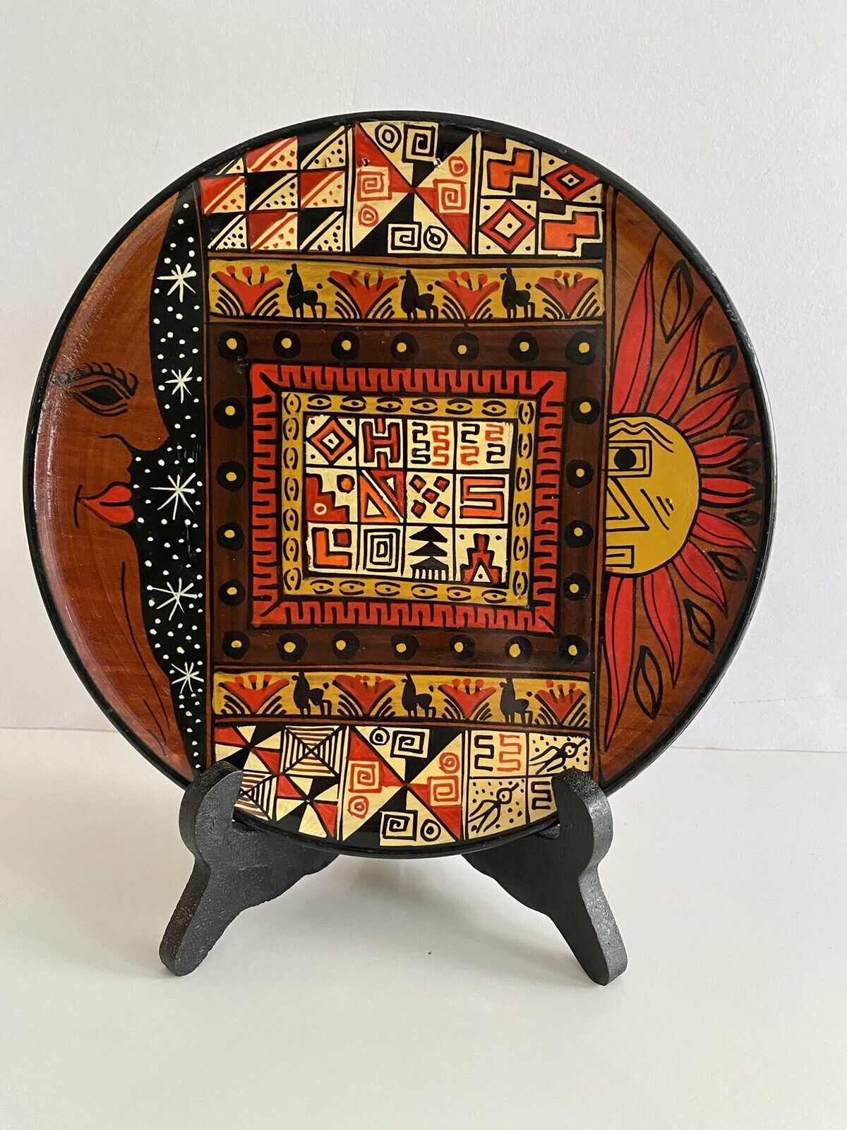 Peruvian wooden plate with Sun, Moon and Nazca symbols7.5” diameter