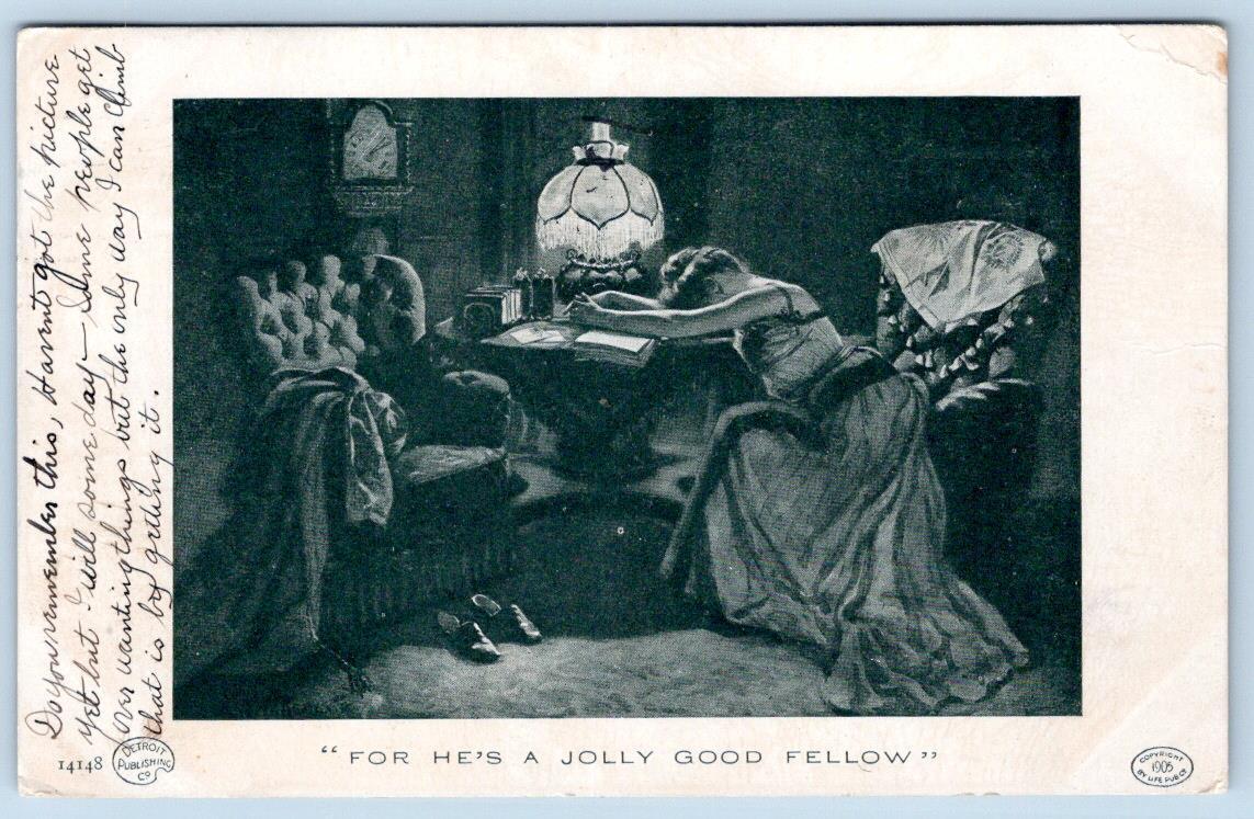 1909 FOR HE\'S A JOLLY GOOD FELLOW WOMAN LAYS ON BOOK TABLE FRINGED LAMP POSTCARD