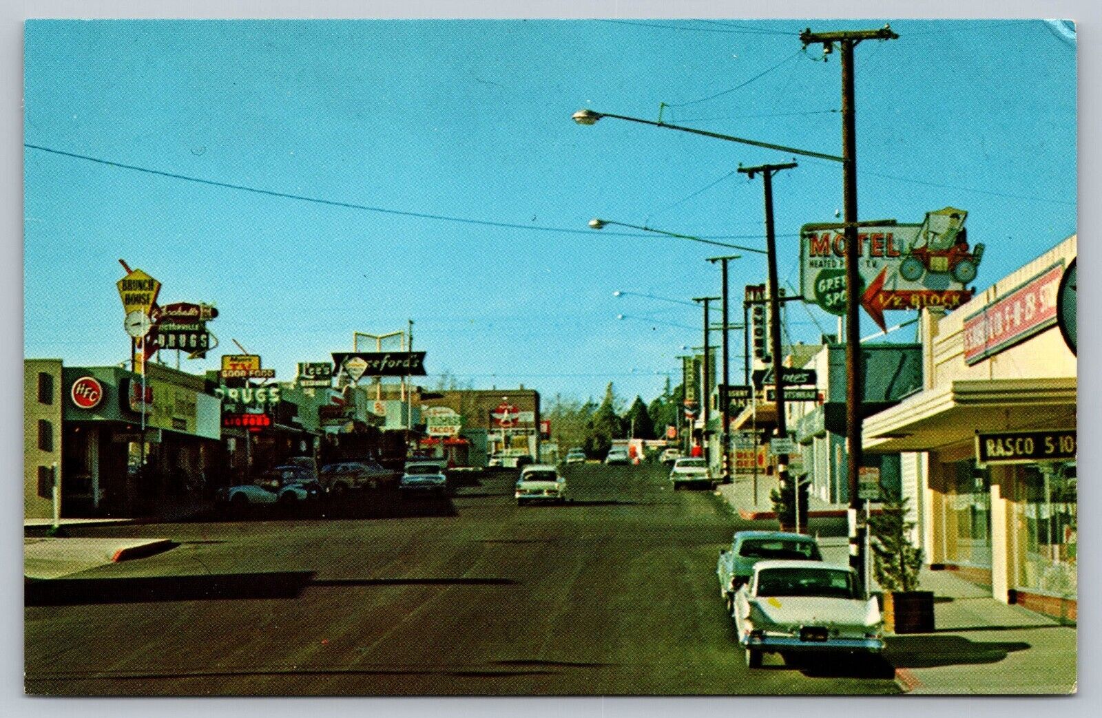 Victorville California CA Street Scene Postcard Drug Store Liquor TV Motel Signs