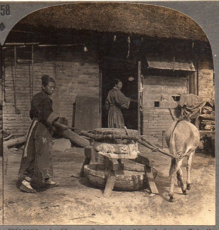 Women in Manchukuo, China, Grinding Beans for Day\'s Meal.  Stereoview Photo