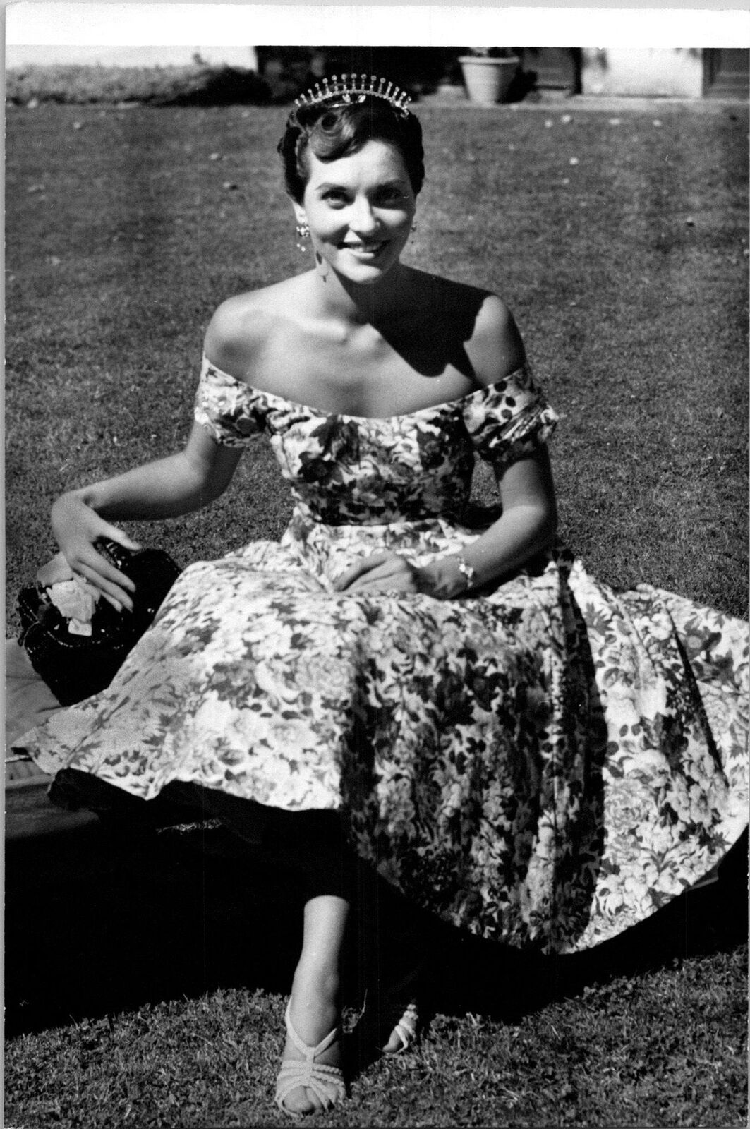 Pretty woman sitting on bench wearing a floral dress & tiara Found Photo V0533