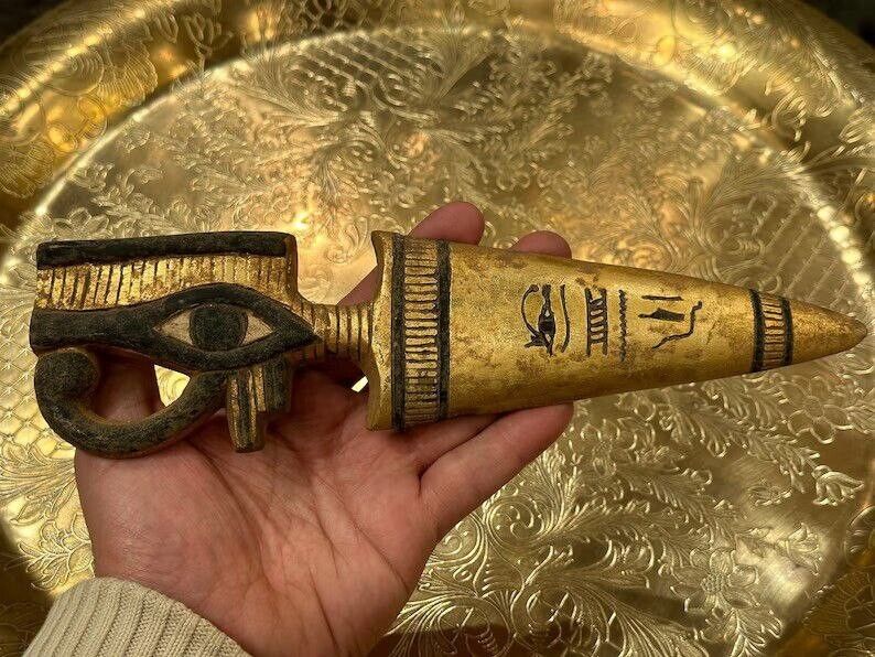 A rare ancient Egyptian amulet made of stone bearing the golden eye of Horus