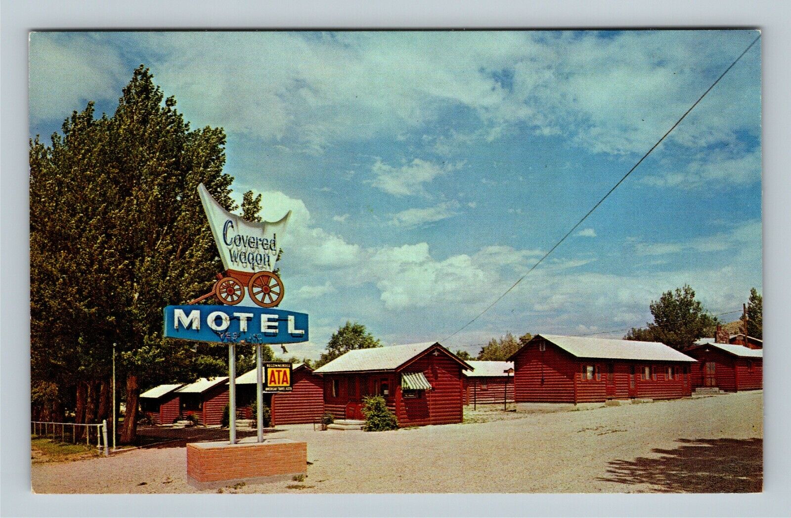 West Cady WY, Covered Wagon Motel Log Cabins Street View Chrome Wyoming Postcard