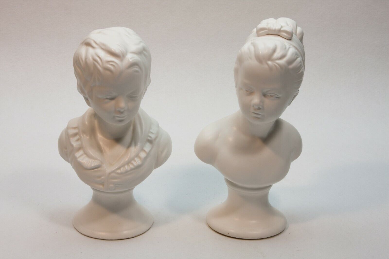 Pair of Mid Century Modern MCM Porcelain Boy and Girl White Matte Bust Statues 