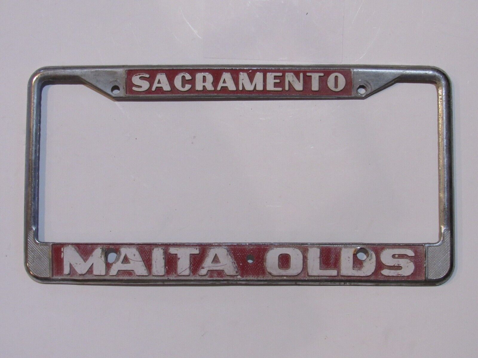 Vintage Sacramento CA Maita Oldsmobile Metal License Plate Frame Embossed Tag