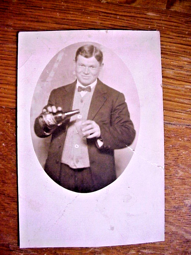 Antique Real Photo RPPC POSTCARD of YOUNG MAN POURING BOTTLE of BEER