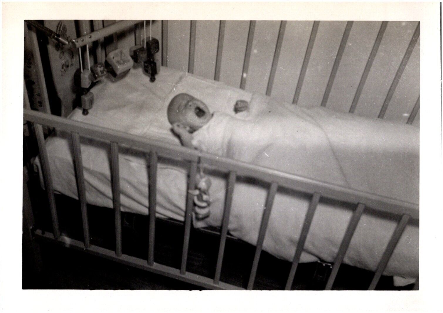 Upset Baby Crying in Her Crib Wailing Infant 1950s Vintage Found Photo