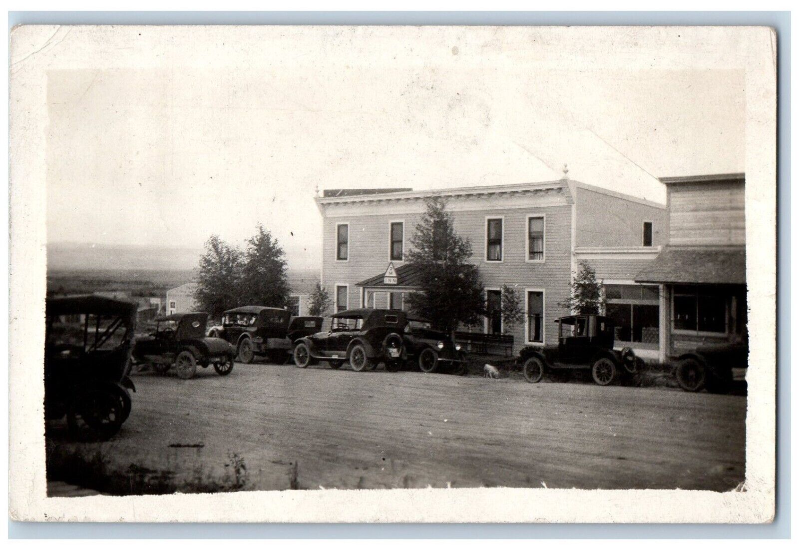 Encampment Wyoming WY Postcard RPPC Photo Hotel Inn Building Cars Scene c1910\'s