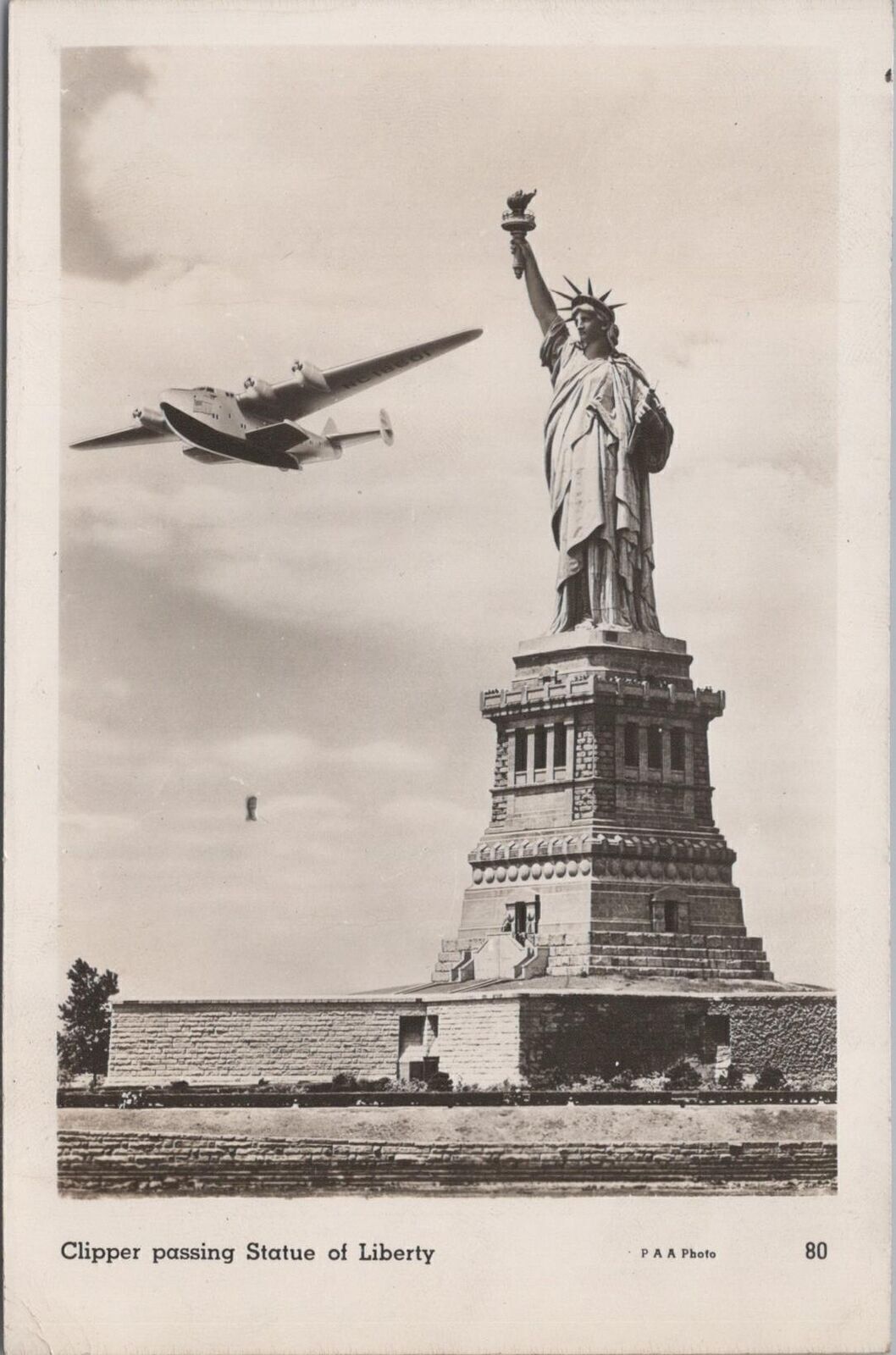 RPPC Postcard Clipper Airplane Passing Statue of Liberty Ellis Island NY 