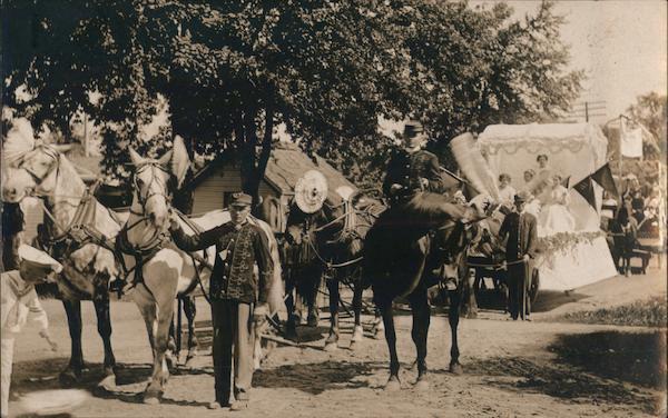1910 RPPC Wakarusa,IN Front of a Horse-Drawn Parade with Decorated Floats