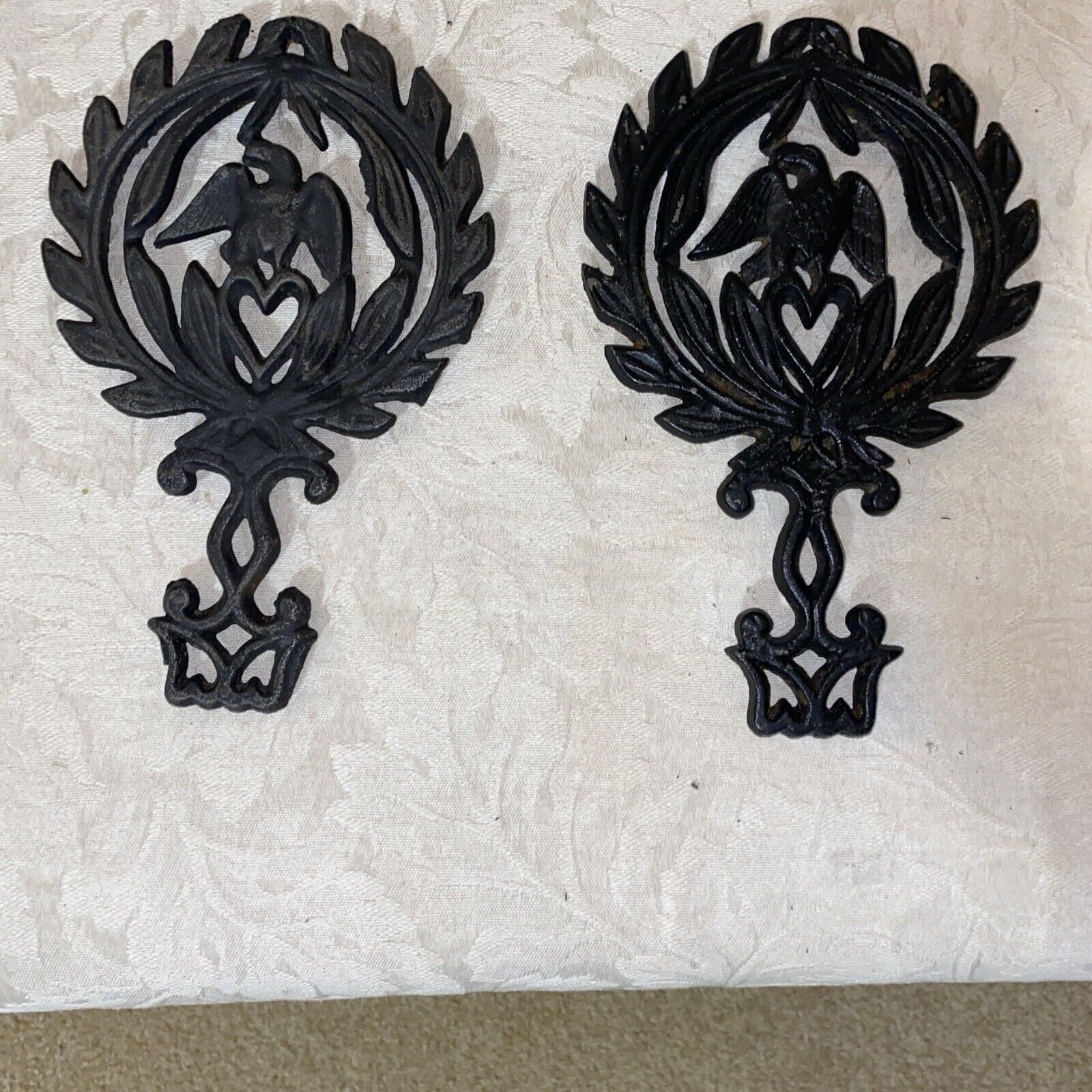 Two Vintage Footed Cast  Iron Trivets With Eagle And Hearts