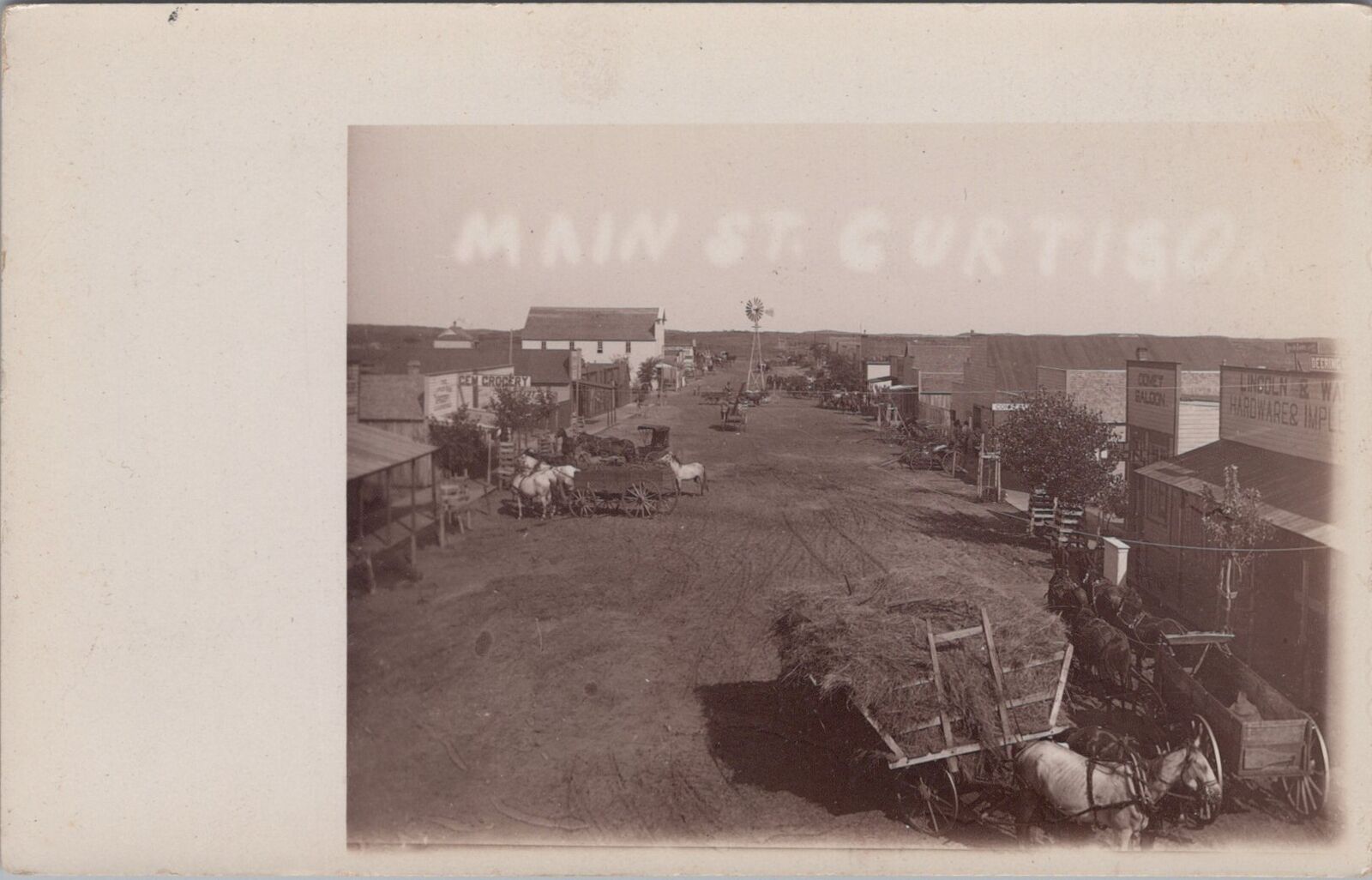 Main Street Curtis Oklahoma Dirt Road Saloon c1910s RPPC Photo Postcard