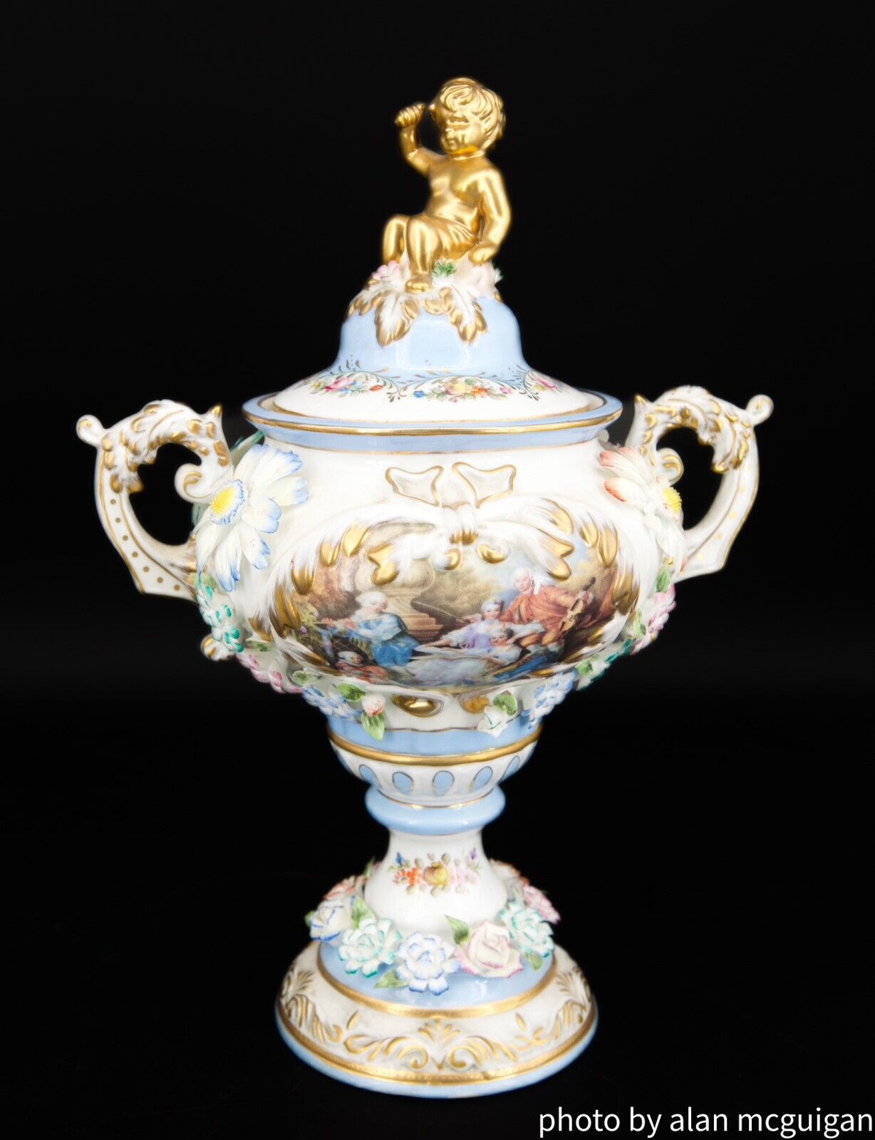Dresden Porcelain  Vase Topped With  Gold Gilded Cherub And A Floral Design