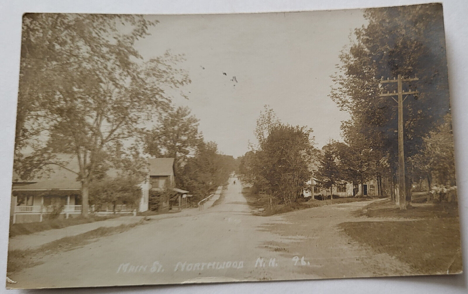 C 1910 RPPC MAIN STREET NORTHWOOD NH HOUSES ALONG ROAD DISTANT HORSE & CARRIAGE