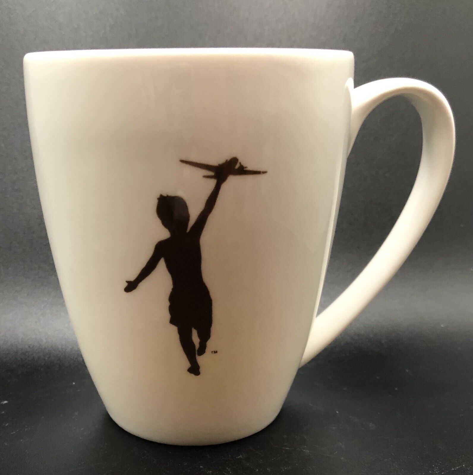 White Storyville Coffee Company Mug “YOUNG BOY RUNNING w/ TOY PLANE” Silhouette 
