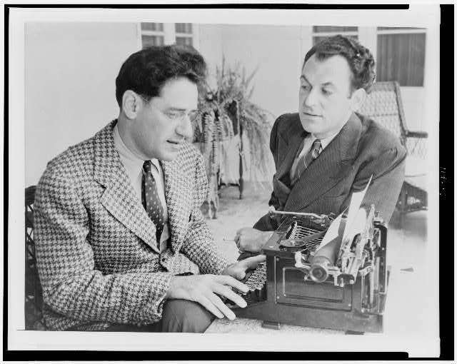 George Kaufman using typewriter,Moss Hart talking,1937,playwrights,outside