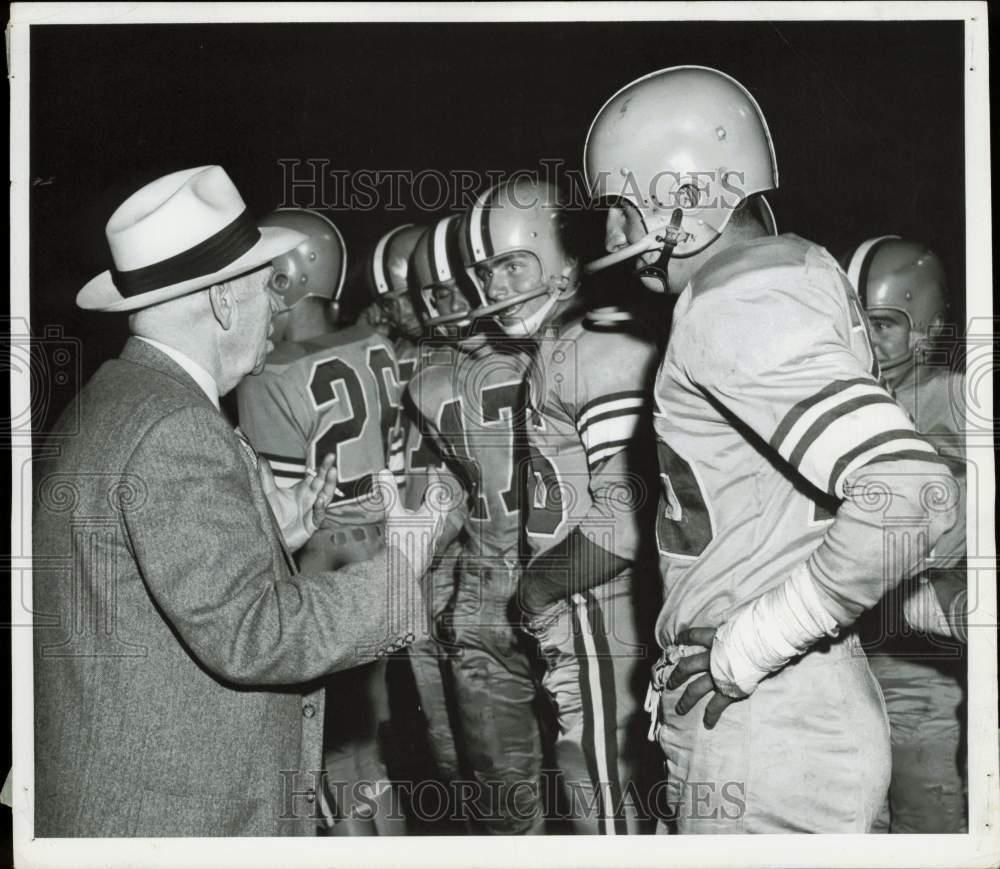 1956 Press Photo An official talks to the football players during game