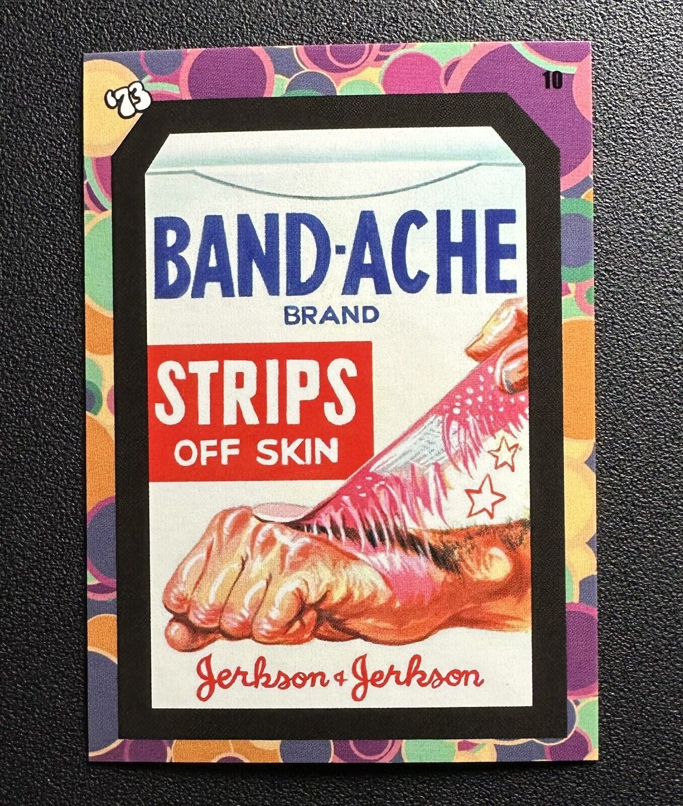 2023 Topps Wacky Packages Flashback ’73 #10 BAND-ACHE STRIPS card in Toploader