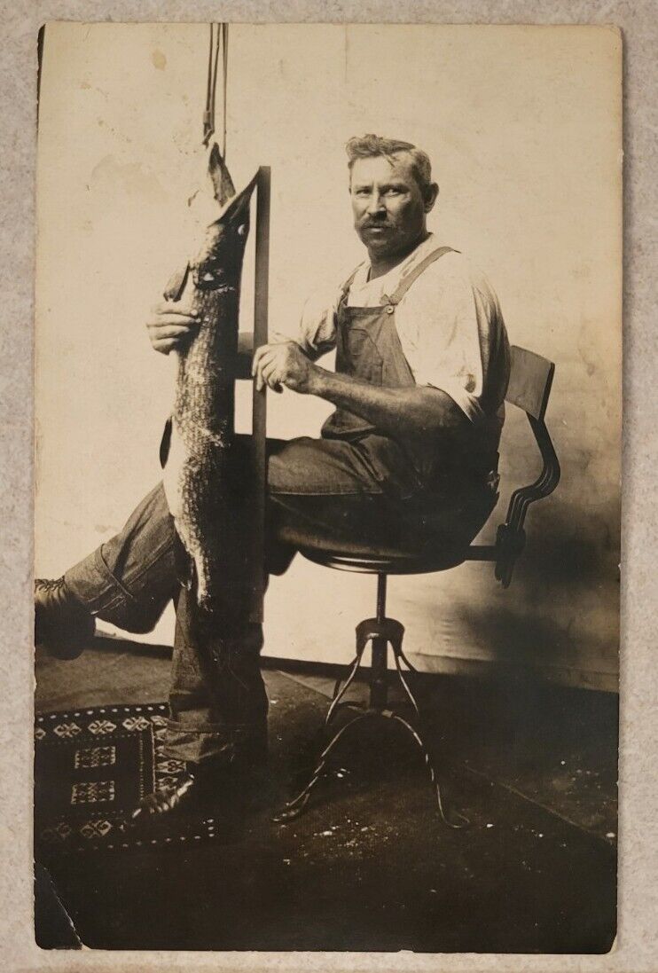 RPPC Fisherman Fishing Measuring Muskie Fish Man Overalls Chair Studio Postcard