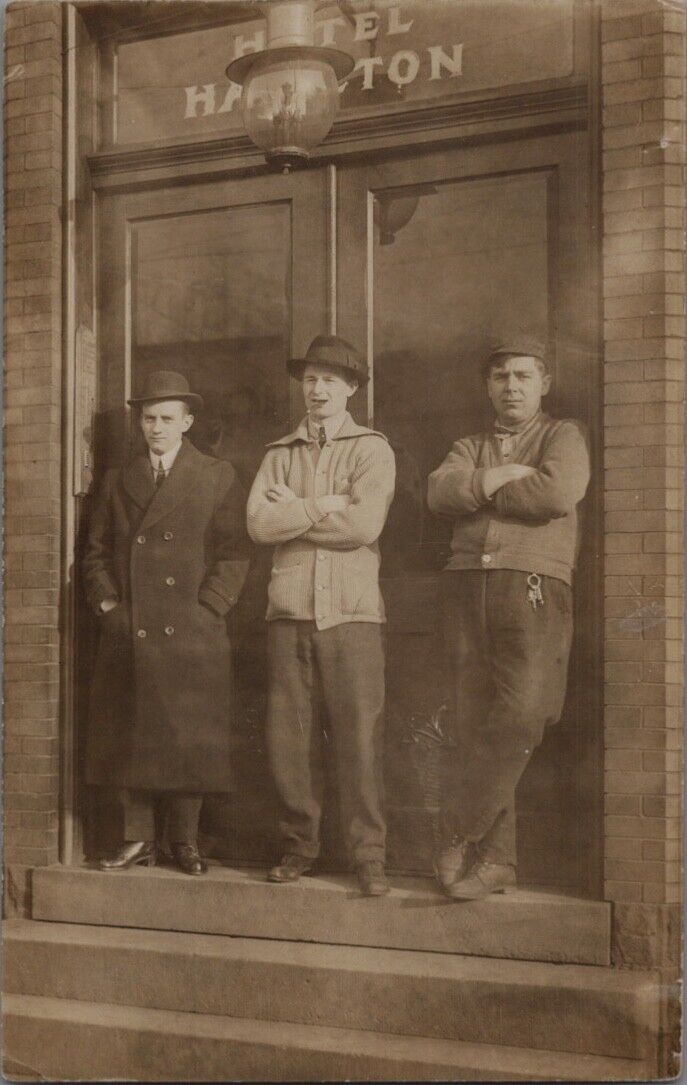 Real Photo Postcard-RPPC-3 Men Stand in Doorway Hotel Hamilton-Man Smokes Cigar