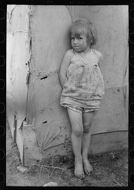 Child of white migrant worker standing by tent home near Harlingen, Texas