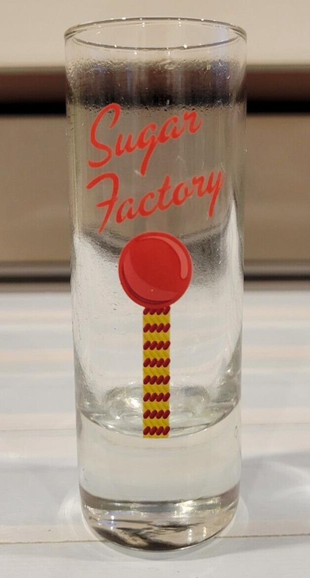 CLEAR SHOT GLASS SUGAR FACTORY IN RED AND YELLOW 4 INCHES HOLDS 2 OZS