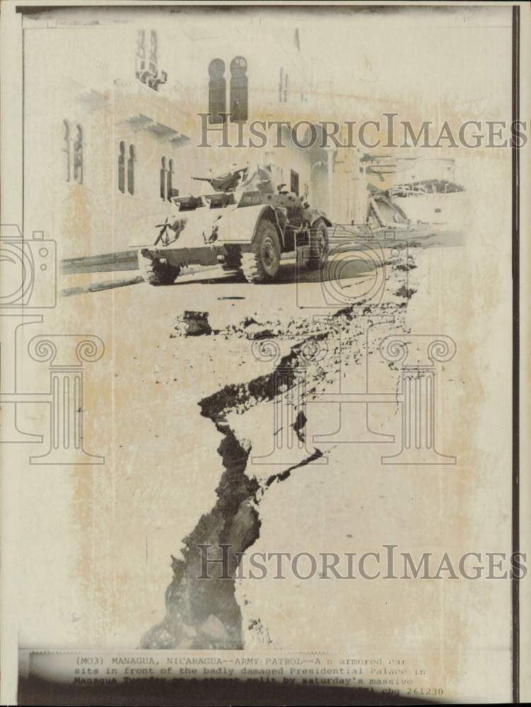 1972 Press Photo Armored car sits on a road split by the earthquake in Nicaragua