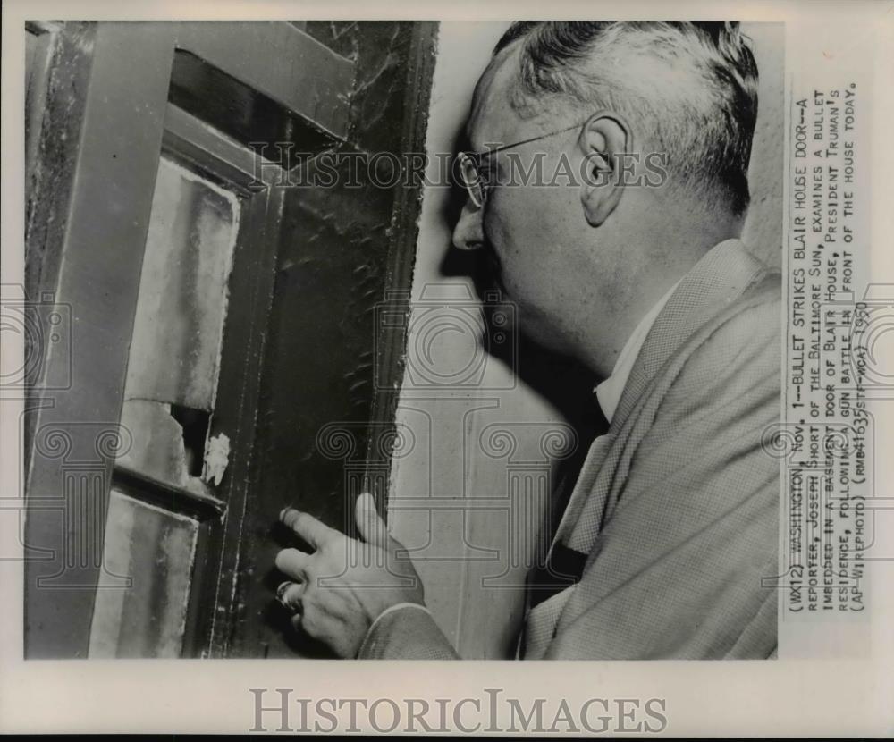 1950 Press Photo Reporter, Joseph Short examines bullet at the Blair House