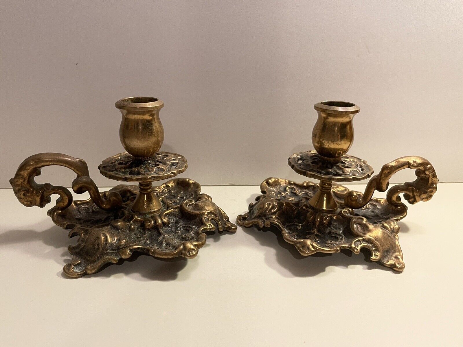Pair of antique hand carved brass candle holders