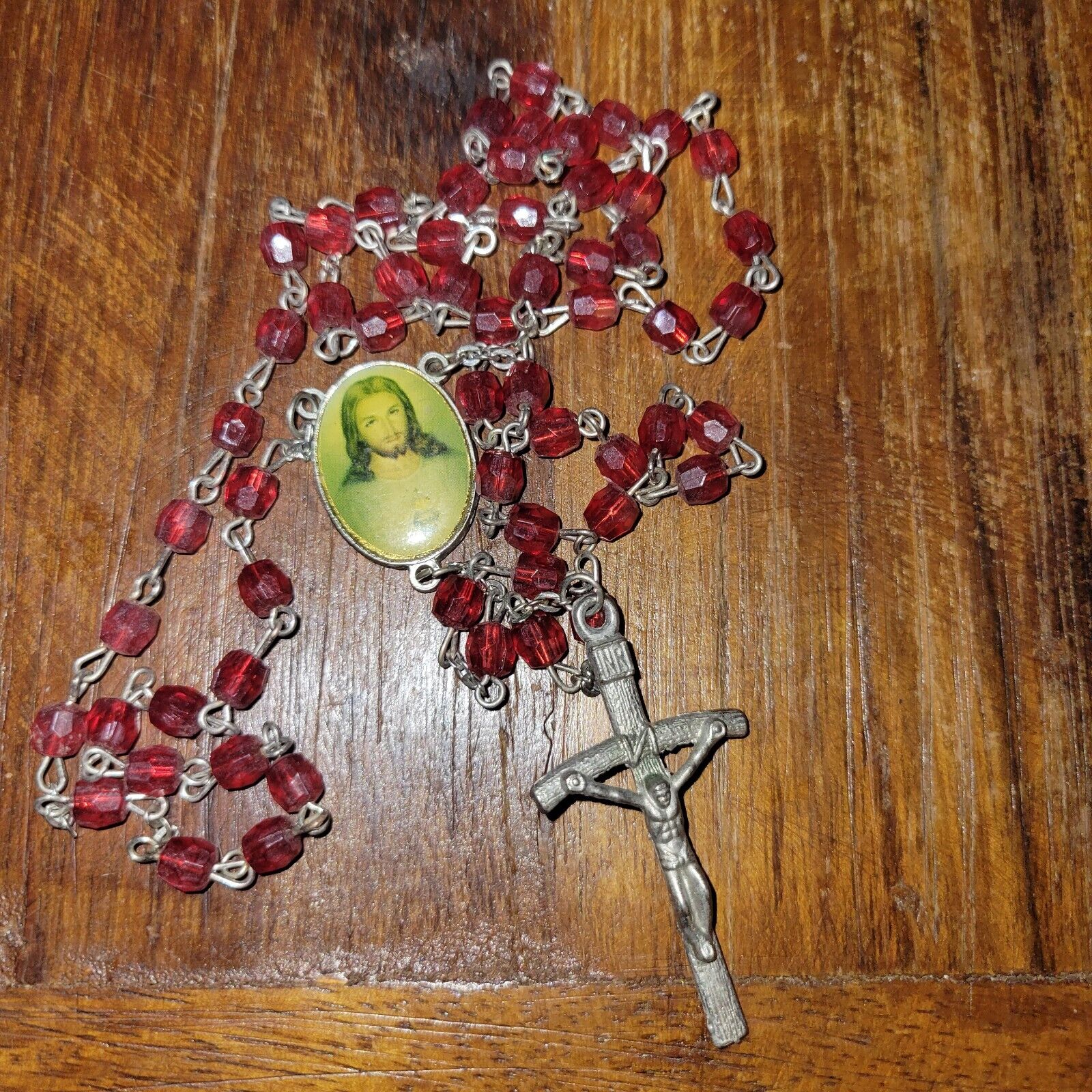 Rosary of cranberry red plastic beads silver toned Crucifix Voval Medallion 
