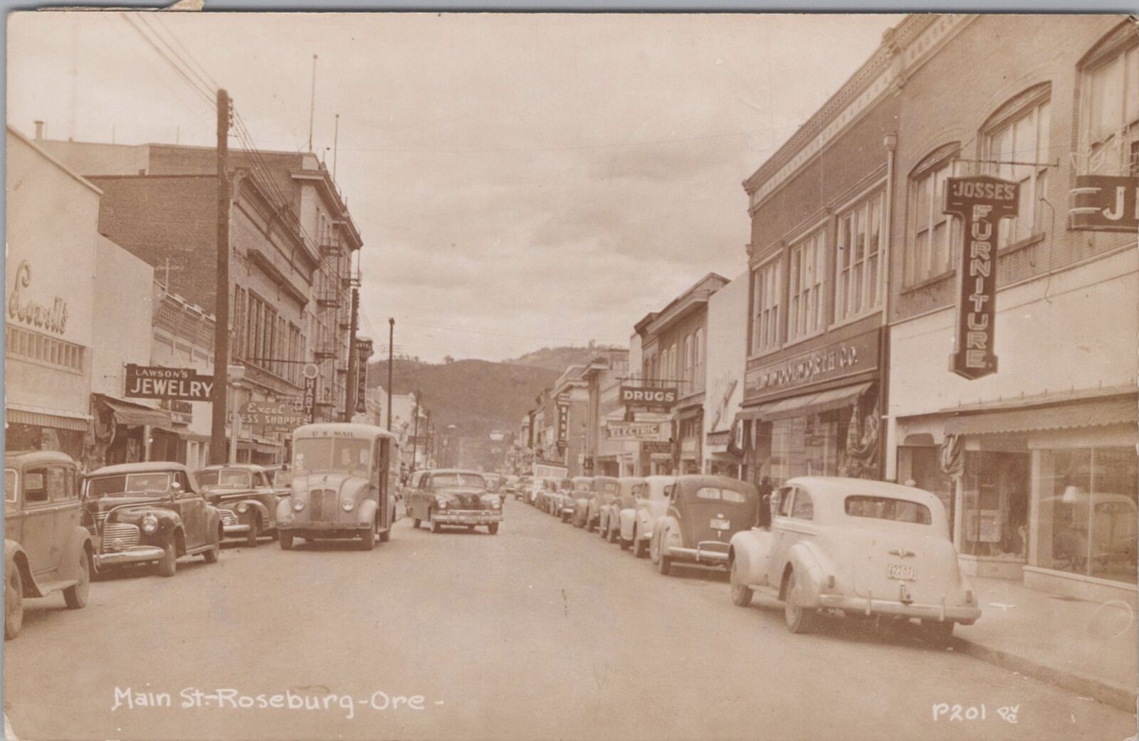 Main Street Roseburg Oregon US Mail Truck Stores Cars 1949 RPPC Postcard