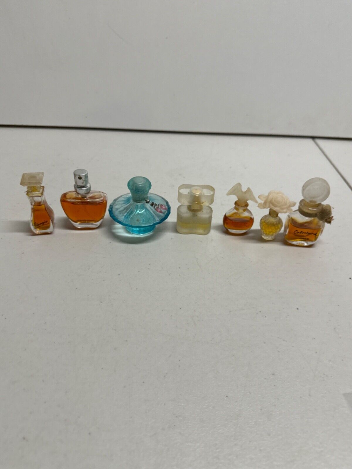 Lot of 7 mini perfume bottles partially full