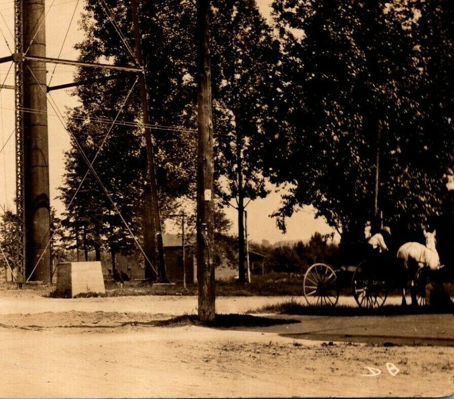 C.1919 RPPC Farwell, MI. Street Scene Water Tower Base Horse & Buggies Postcard