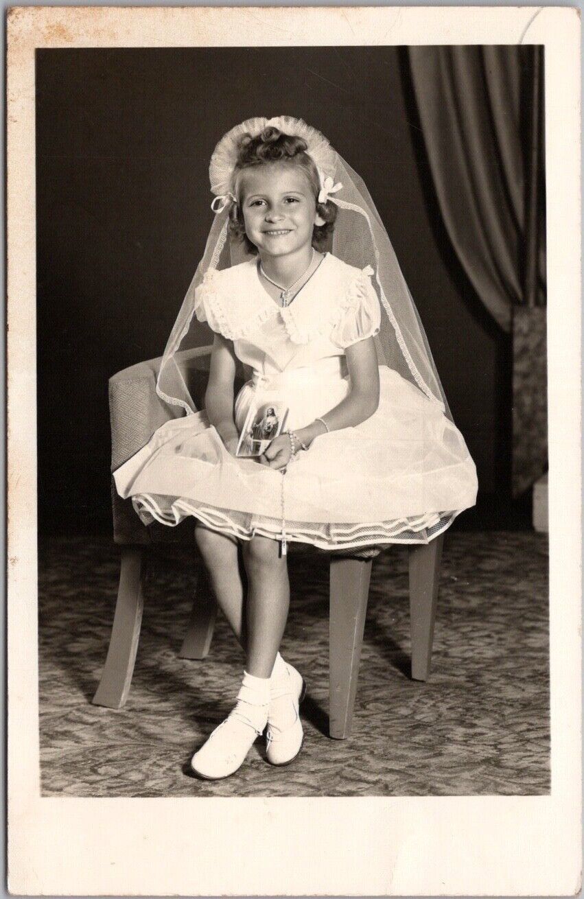 c1950s RPPC Photo Postcard Girl in White Confirmation Dress, Holding Jesus Card