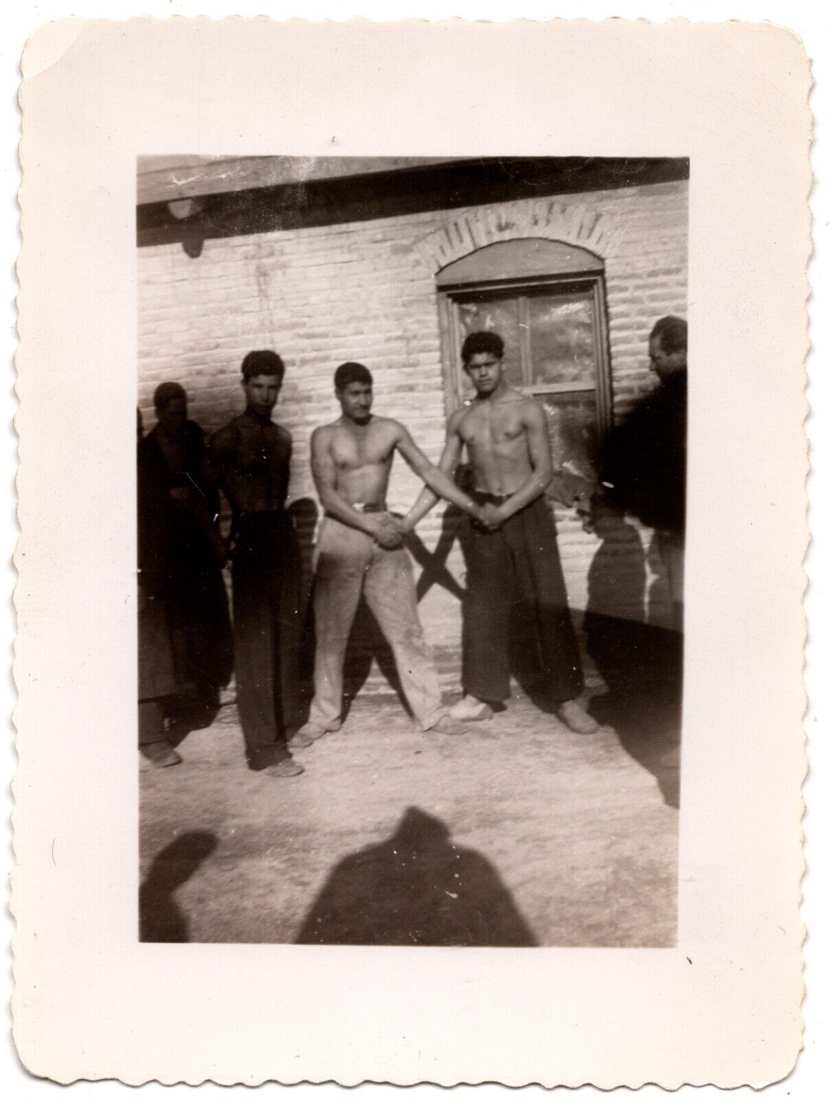 VINTAGE B&W SNAPSHOT CIRCA 1930s SHIRTLESS MEN HOLDING HANDS OUTSIDE
