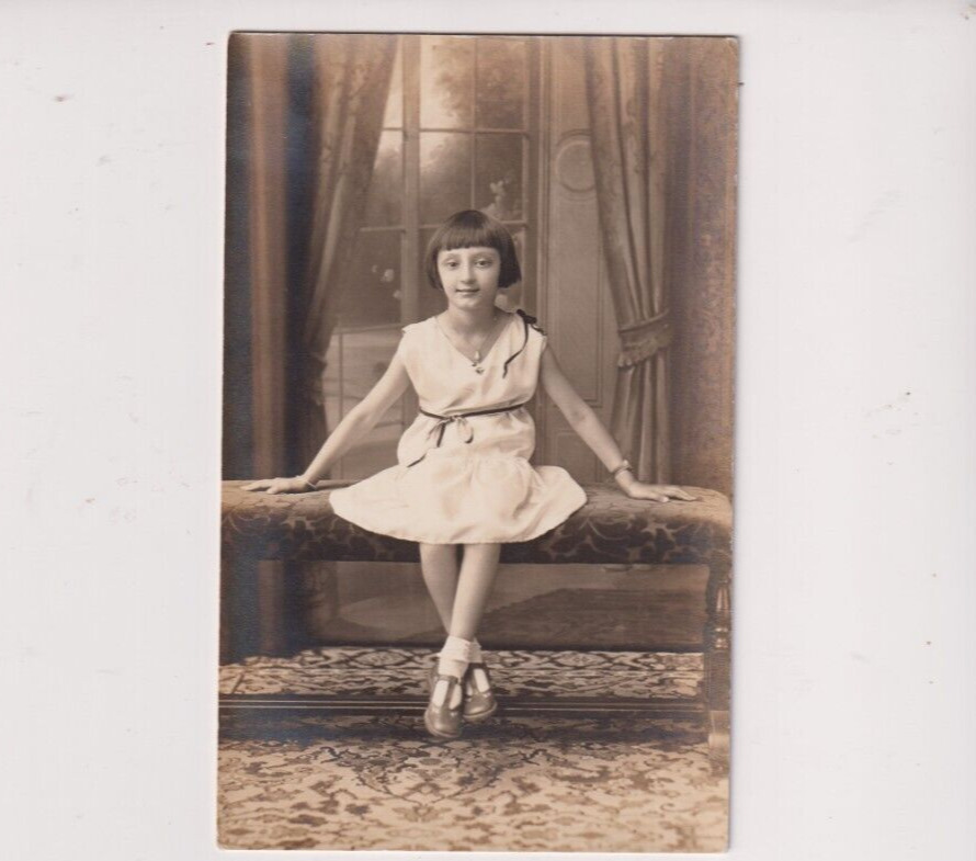 Postcard RPPC Cute Young Girl Posing On Bench Real Photo Postcard c. 1925-1934