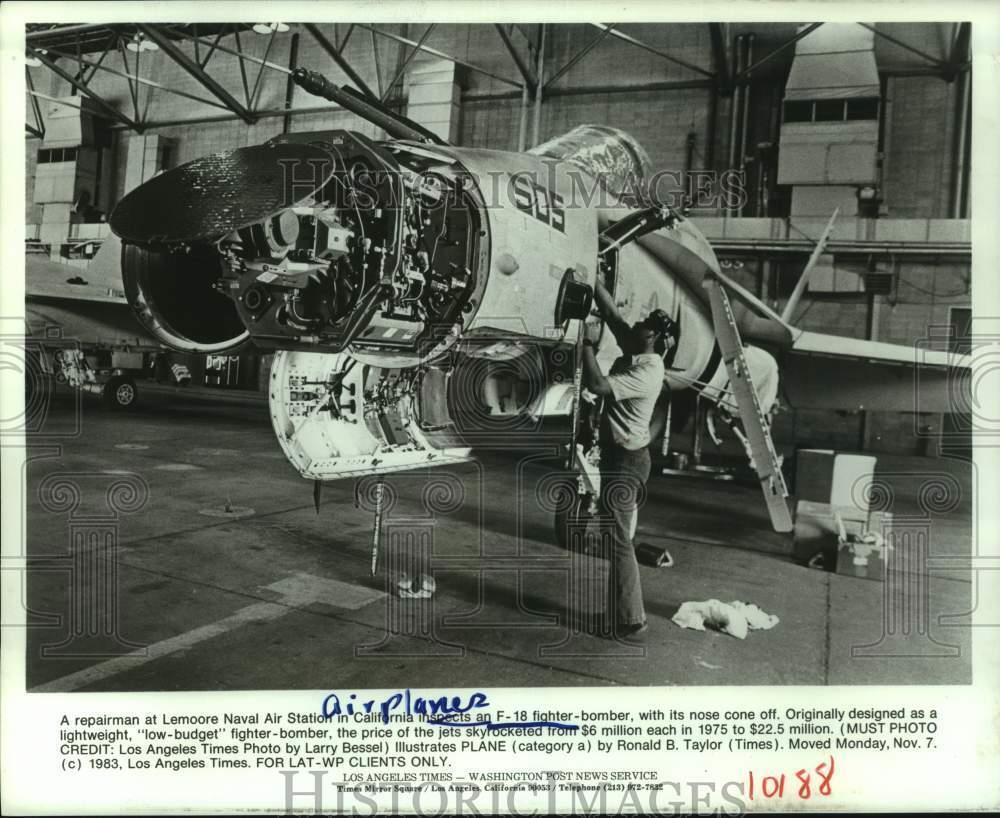 1984 Press Photo Repairman at Lemoore Naval Air Station, CA, inspects F-18 plane