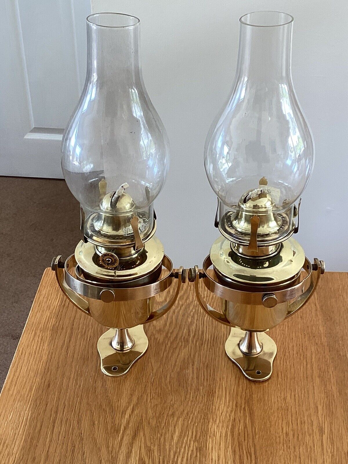 A Pair Of Brass Gimbal Oil Lamps.