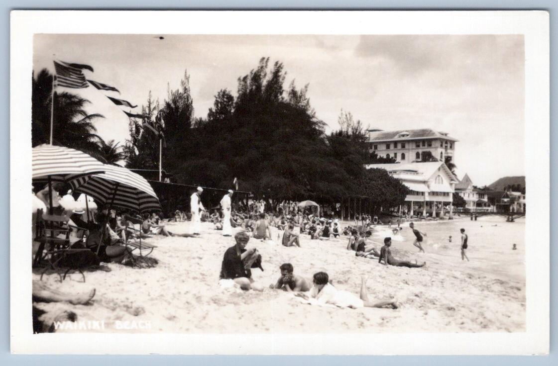1930's RPPC WAIKIKI BEACH AMERICAN FLAG SUNBATHERS HOTELS SAILORS PHOTO POSTCARD