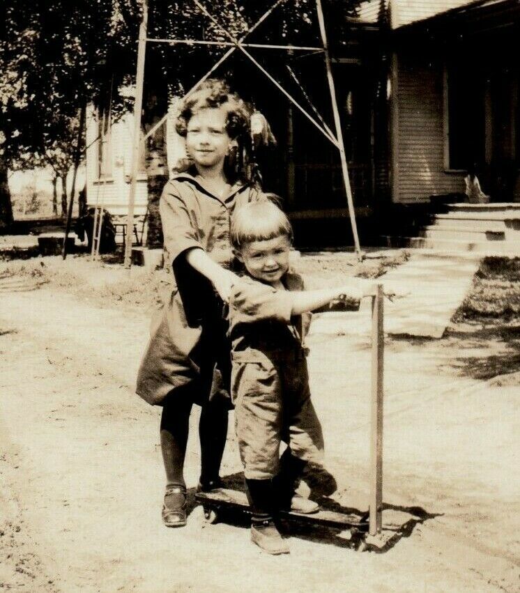 Children Young Boy and Girl On A Wood Scooter 3.5\