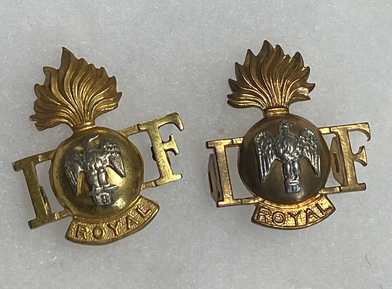 Two Royal Irish Fusiliers Shoulder Title Badges