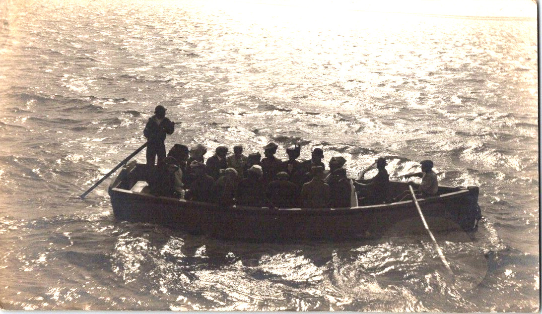 RPPC Boat full of people being rescued? rough waters postcard a47
