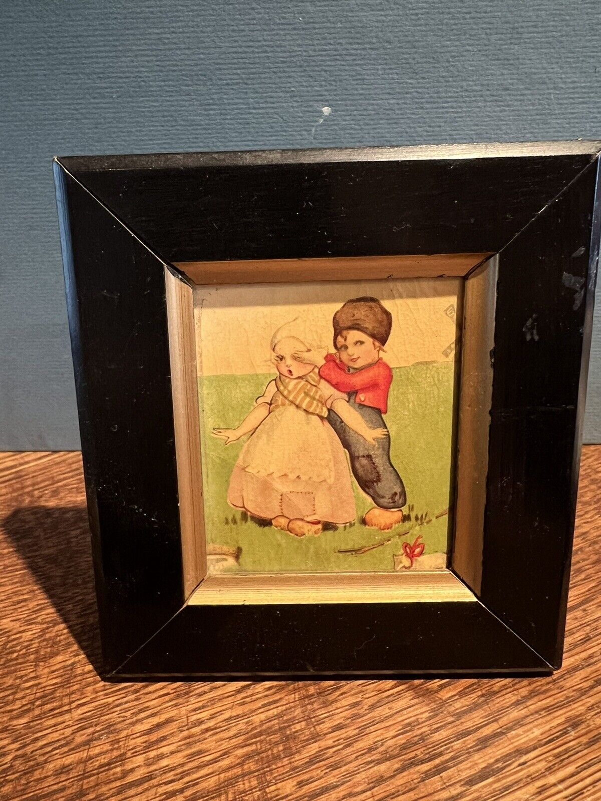 Small antique picture of boy and girl playing, possibly dutch