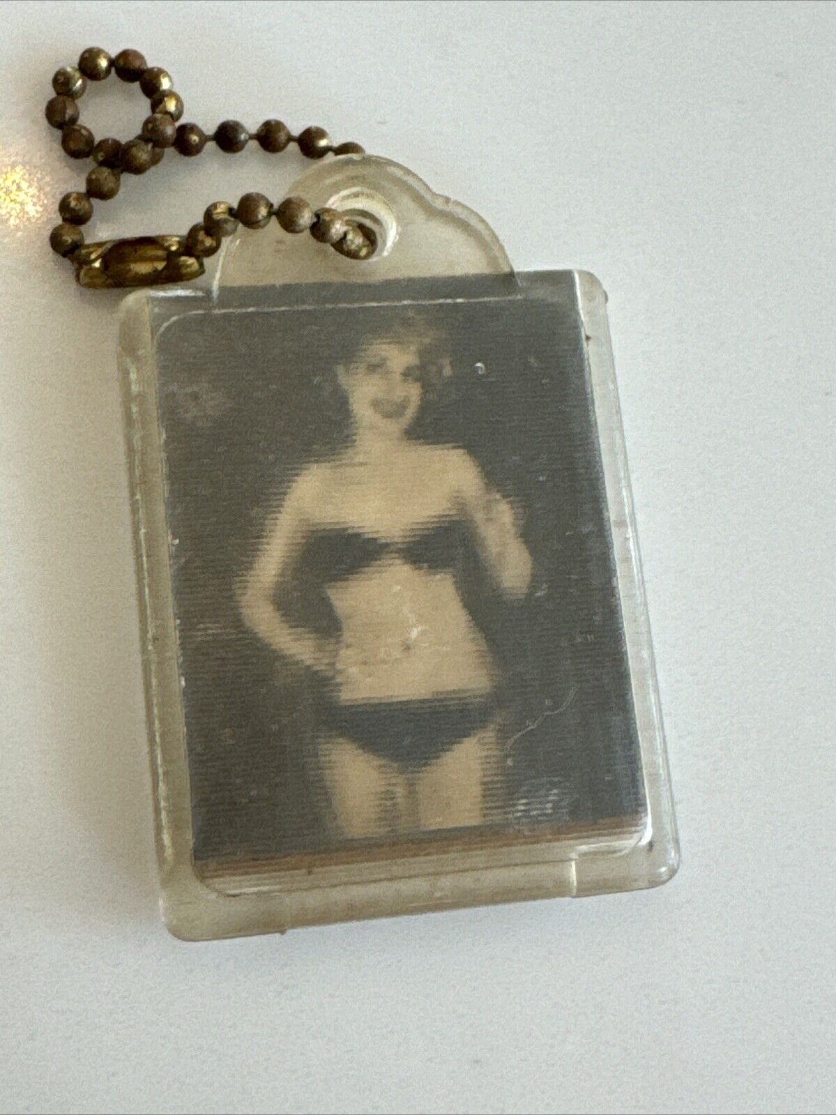 Vintage 1960’s Pinup Dancing Girl Keychain Lithograph (Dances When Moved)