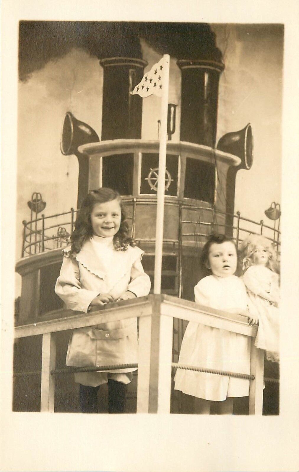 c1915 RPPC Postcard; 2 Little Girls & Doll, Photographer\'s Cruise Ship Backdrop