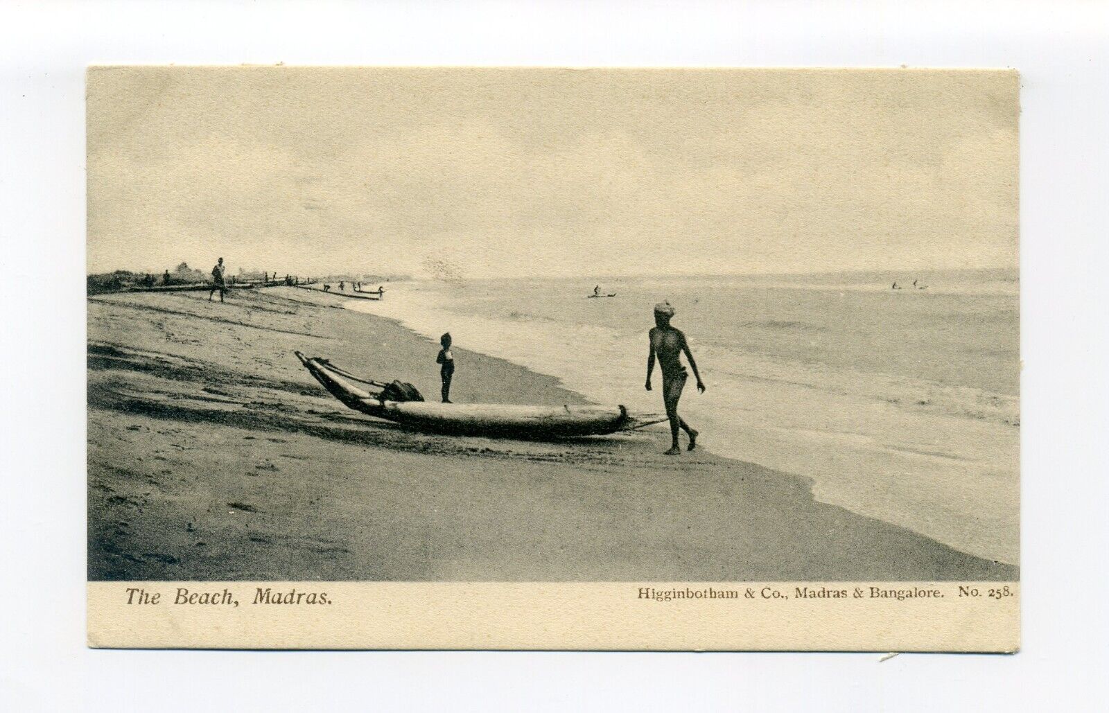 India, Chennai postcard, people, tradional boat, gentle surf on beach