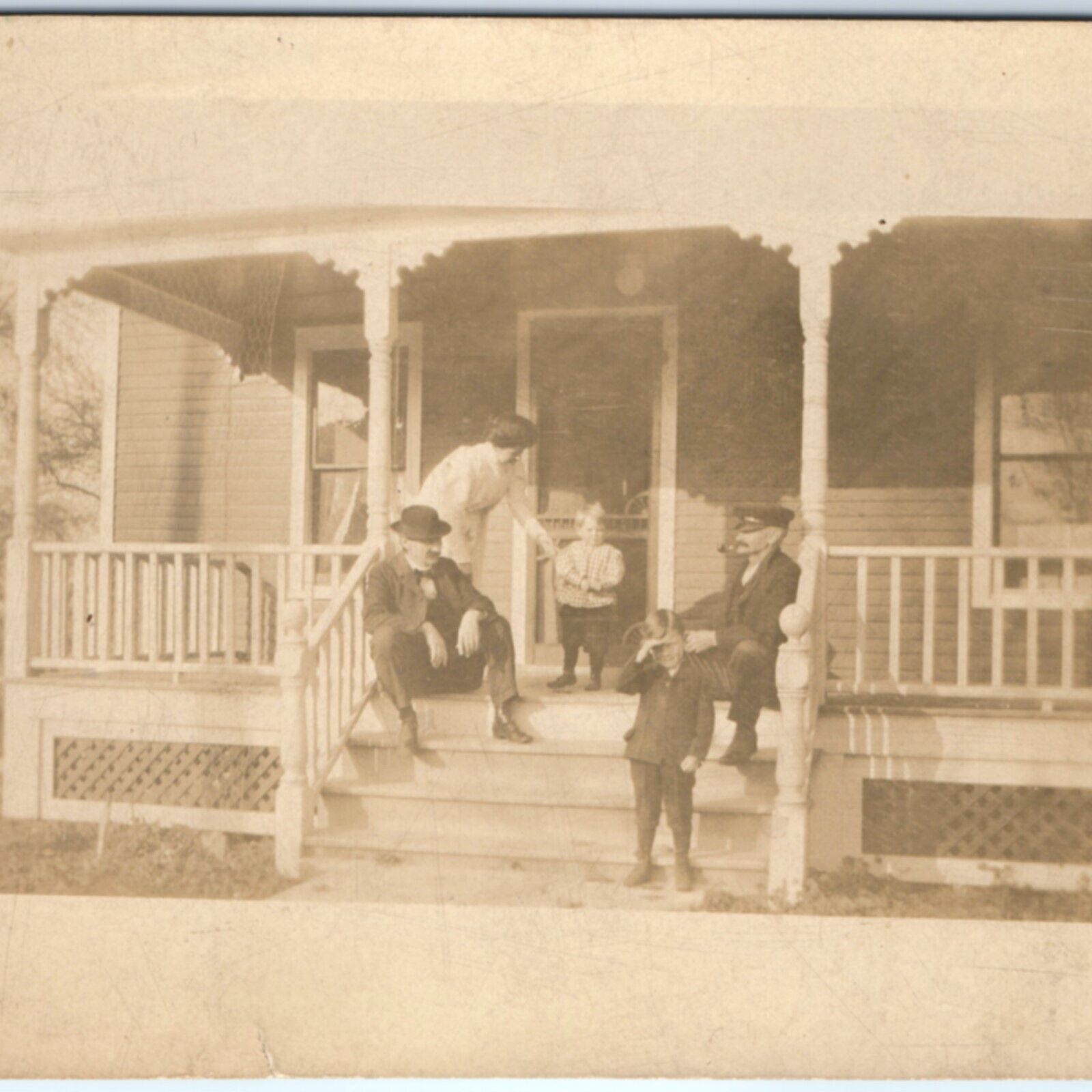 c1910s Handsome Little Boys Family Porch RPPC Conductor Man Smoking Photo A139